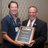 Brian Fullem, DPM (left) accepts Richard Schuster Award from AAPSM Past President David Davidson, DPM.  Dr. Fullem accepted the award on behalf of award recipient Amol Saxena, DPM.