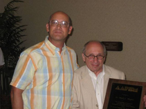 Dr. Pat Nunan presents Dr. Mark Wagner from Special Olympics, Inc. with the AAPSM President's Award in Hawaii