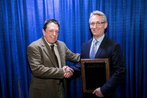 AAPSM President Alex Kor, DPM (l) congratulates AAPSM Excellence in Athletic Training Award recipient Edward Lacerte at the NATA meeting in Baltimore Friday afternoon