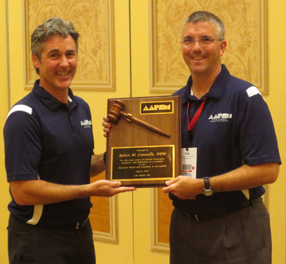 AAPSM Immediate Past President Rob Conenello, DPM (r) receives his presidential plaque recognizing his years of service on the AAPSM Board from incoming President Paul Langer, DPM.  