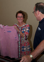 Incoming AAPSM President Karen Langone, DPM accepts the new AAPSM "pink apparel" from outgoing President David Davidson, DPM