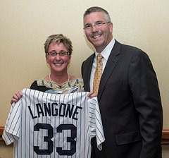 Past President Karen Langone, DPM (l) receives a commemorative #33 New York Yankee jersey from AAPSM incoming President Rob Conenello, DPM recognizing her as the 33rd president of the AAPSM.