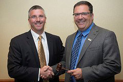 Incoming AAPSM President Rob Conenello, DPM (l) presents outgoing President Jamie Yakel, DPM with the presidential plaque and gavel for his years of dedicated service.