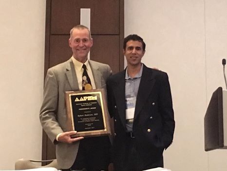 AAPSM President Amol Saxena, DPM (r) presents the 2017 President’s Award to Robert Anderson, MD – team physician for the Green Bay Packers.