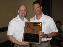 Dr. Bruce Williams presents outgoing President Dr. Matt Werd with the AAPSM Presidential Plaque in Hawaii